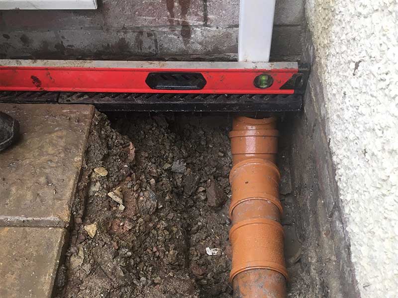 Drainage installation team working on a property in London